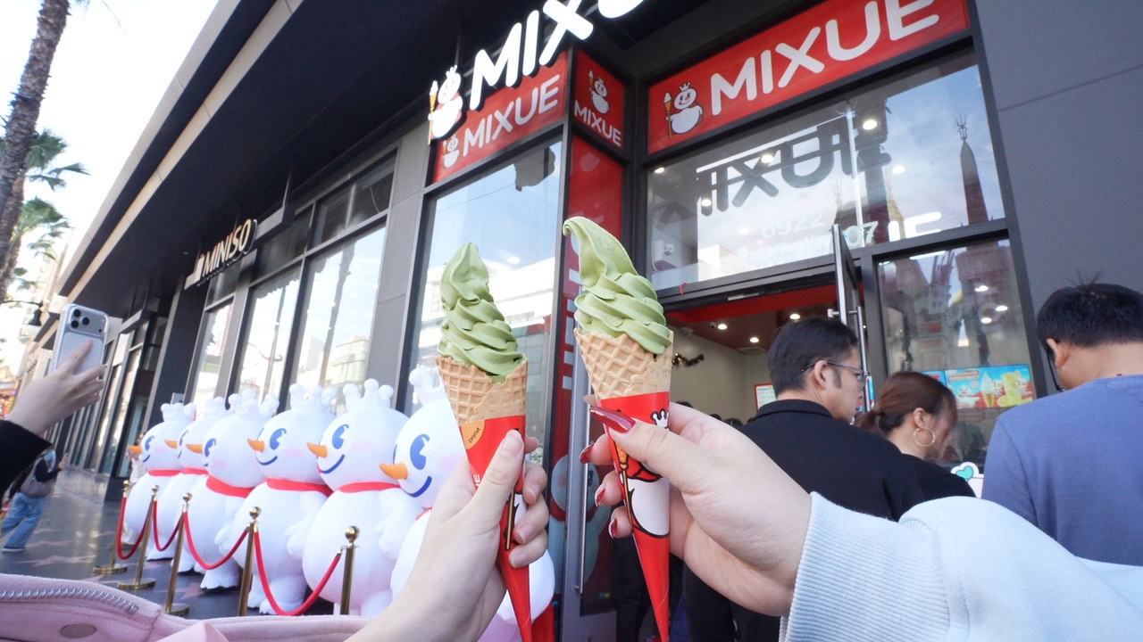 MIXUE store grand opening ceremony with customers lined up outside, celebrating the launch of a new location